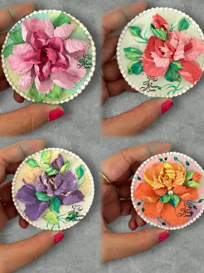 A collection of four of my super cute and pretty sculpted fridge magnets. Each one is a miniature artwork, featuring a different type of flower and color combination on a 4-inch circular base.