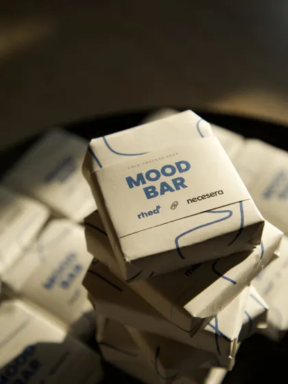 A stack of the custom "Mood Bar" soaps, showing the clean, branded packaging I designed for the Necessara and Rhea Kapoor PR mailer.