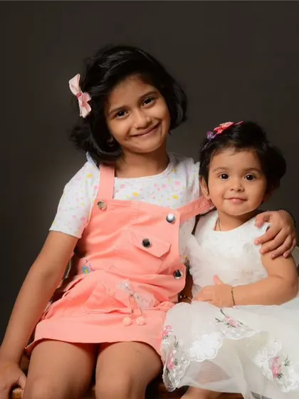 A happy portrait of two sisters. Capturing the bond between siblings is one of the highlights of family photography.