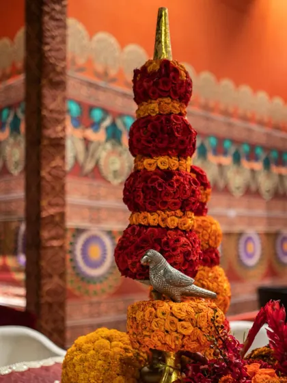 A detail of the temple-inspired floral spire, showing the careful layering of colors and the charming bird accent.