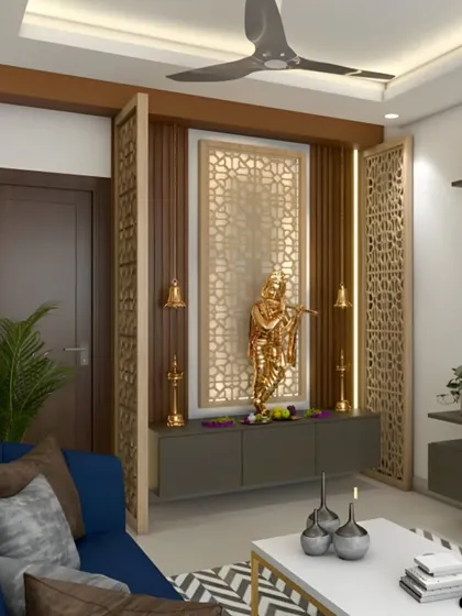 Here, I integrated the pooja area into the living room using decorative jali partitions. This design defines the sacred space while keeping it connected to the rest of the home, featuring a golden Krishna idol as the centerpiece.