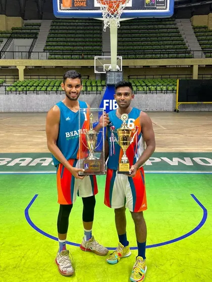 With a teammate, showcasing our trophies after winning the KSBBA 'C' Division league. This win promoted us to the next division.