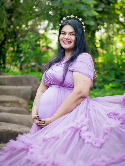 A radiant solo portrait of the mom-to-be. Her smile and the beautiful lavender gown create a feeling of pure joy and anticipation.