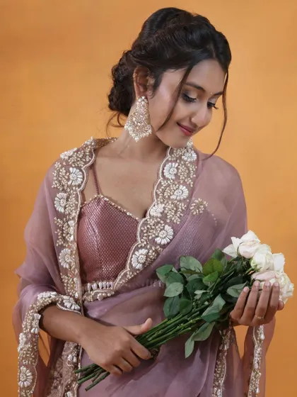 This portrait highlights the delicate embroidery on a modern organza saree. By having the model hold a bouquet of white roses, I added a touch of romance and softness that complements the intricate floral details on the garment.