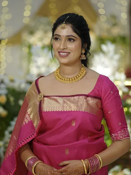 For her Oorkuduva ceremony, this bride wore a bright pink saree. I created a soft, glowing makeup look to match.