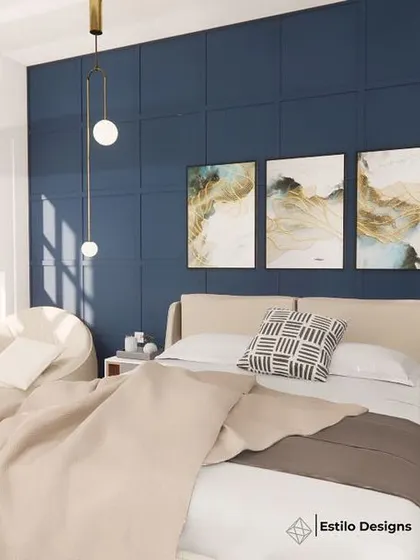 For this daughter's room, I used a deep blue accent wall with subtle molding to create a sophisticated backdrop. The design combines modern cottage elements with sleek furniture and abstract art, resulting in a chic and personal space.