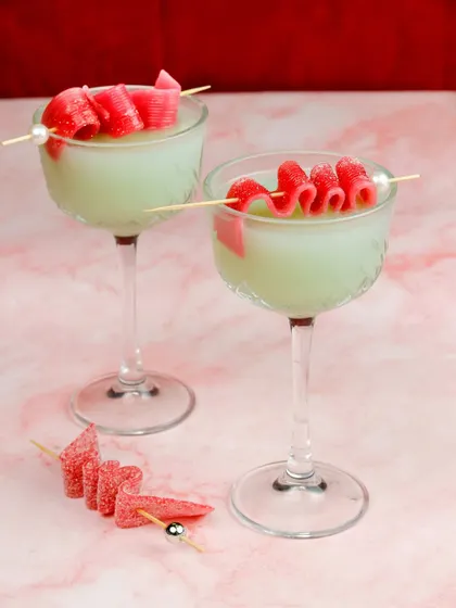 A fun and whimsical bubblegum cocktail with a candy garnish, created for a special Valentine's Day menu.