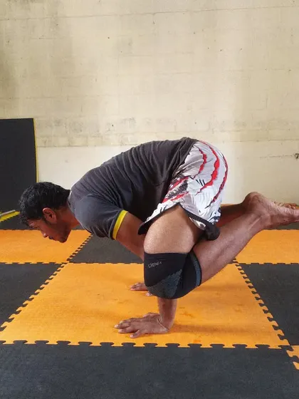 Practicing the Bakasana (Crow Pose) in yoga after a tough strength session. Flexibility and balance are just as important as strength.