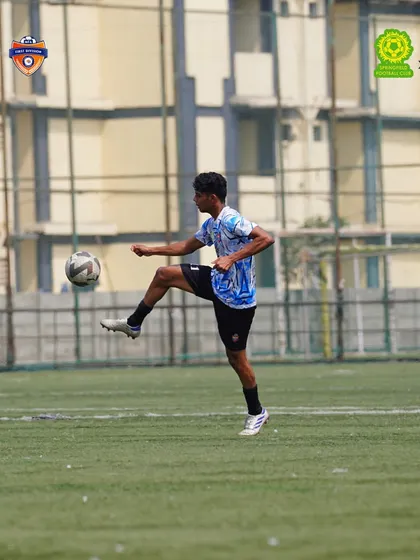 Masterful ball control. A player effortlessly controls the ball mid-air, a skill honed through countless hours of technical training at our academy.