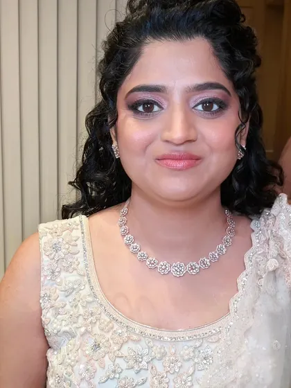 A close-up of her reception makeup. The soft pink and brown tones on her eyes complement her outfit perfectly.