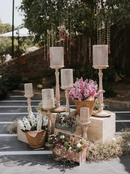 A beautiful decor corner with wooden lanterns and baskets of fresh flowers on our striped walkway.