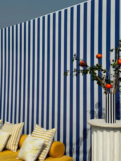 From concept to execution in just 42 hours. This St. Tropez inspired decor in Ahmedabad involved transforming a bungalow with custom-painted walls, fruit-based installations, and unique props, all on a tight deadline.