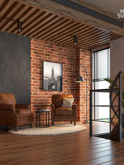 A cozy seating area on the mezzanine floor, demonstrating our ability to create functional and inviting spaces. The combination of leather armchairs, warm wood, and industrial-style railings continues the home's aesthetic.