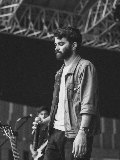 A moment of reflection on stage, captured in timeless black and white.