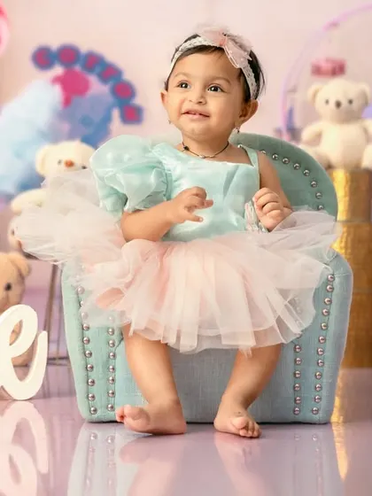A happy smile from the birthday girl in her sweet and colorful Candyland setup.