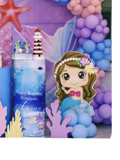 A cute mermaid cutout and themed pedestal for Aarna's birthday. These character elements are always a favorite with the kids.