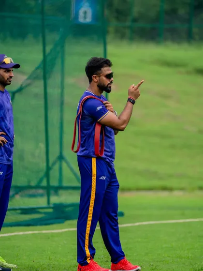 On the field, communication is key. Here I am during a training session, discussing strategy and technique with the players. My role extends beyond the gym to ensure the strength we build translates into smart, effective performance during a match.