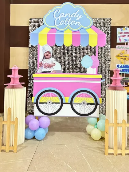 A fun photo booth prop designed as a cotton candy cart for a 'Candyland' party.