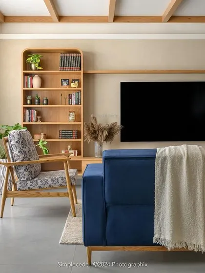 The 'Cover me in Sunshine' living room embodies a modern cottage vibe, with exposed rafters, arched entryways, and a soothing palette of beige and blue.