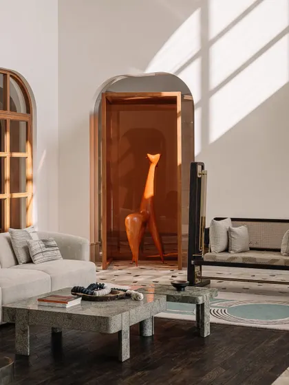 A view from the living area looking towards the amber-colored art installation in the galleria. This perspective shows how we create visual connections and surprising moments throughout the home.