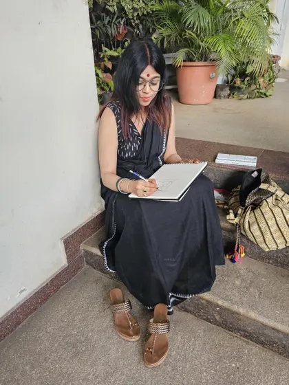 Doing what I love the most. A candid shot of me doing a live sketch on the last day of our exhibition. This photo perfectly defines me.