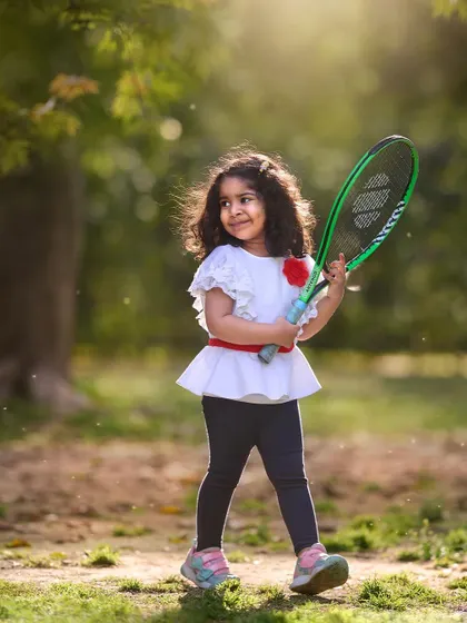 Getting ready to serve up some fun. A sports theme, like this tennis session, is a great way to capture the active and energetic personality of an older child.