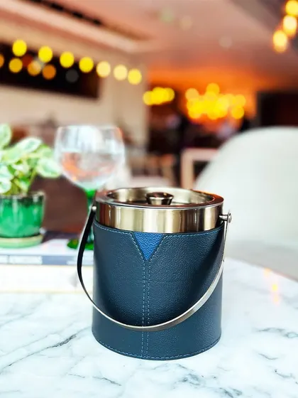 Our Bella Pelle Casa Ice Bucket, with its sleek design and timeless charm, is the ultimate accessory for any soirée. The combination of stitched leather and polished metal is pure sophistication.