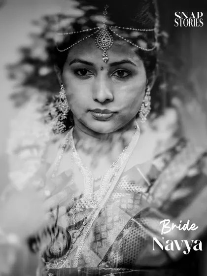 A stunning black and white portrait of a bride, creating a timeless and dramatic look. This artistic shot highlights her beautiful features and traditional jewelry.