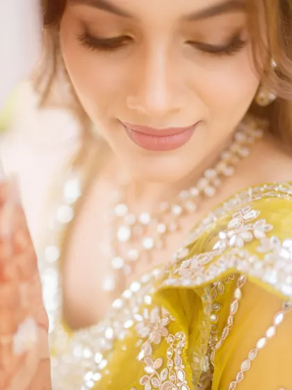 A close-up of the bride's makeup for her carnival event. The look is natural with a focus on flawless skin.