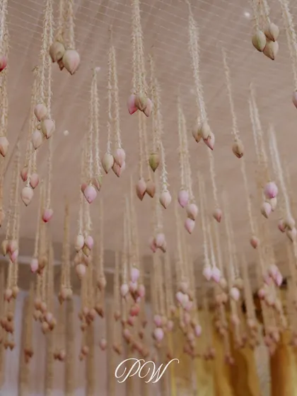 A beautiful detail of hanging lotus buds. This delicate floral installation adds a touch of grace and divinity to the wedding decor.