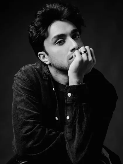 The same corduroy look in a dramatic black and white portrait. This demonstrates the versatility of the outfit under different lighting and moods.