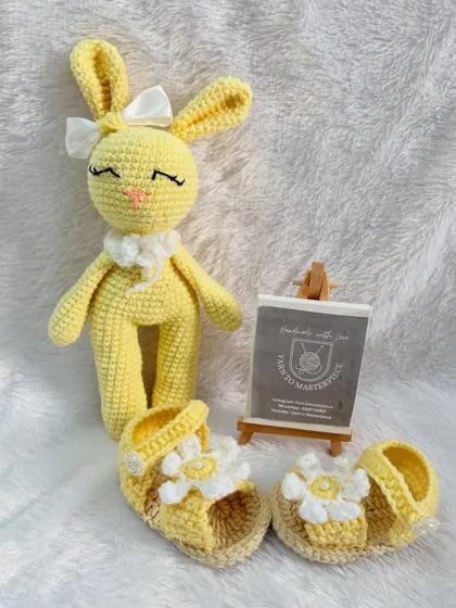 A sunny yellow themed gift set, including a pair of daisy-adorned baby sandals and a matching yellow bunny doll. It's a perfect gift for a summer baby.