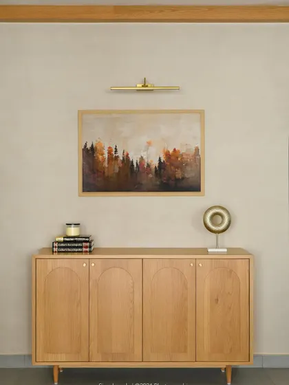 This elegant sideboard features a light oak finish with subtle arched grooves on the doors. It's a minimalist piece that adds a touch of modern cottage charm to the space.