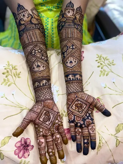 A royal-themed design with palace architecture, doli-bearers, and a Ganpati motif hidden within a diamond-shaped pattern.