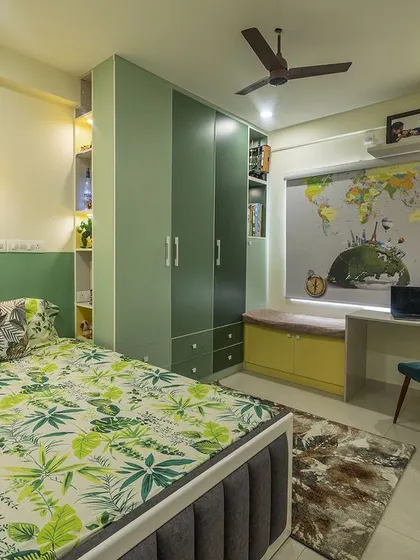 A full view of the travel-themed kids' room, showcasing the smart use of space with integrated wardrobes, a study desk, and a bay window seat.