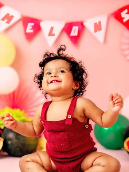 A look of pure happiness. This watermelon-themed session is perfect for a summer baby's first birthday celebration.