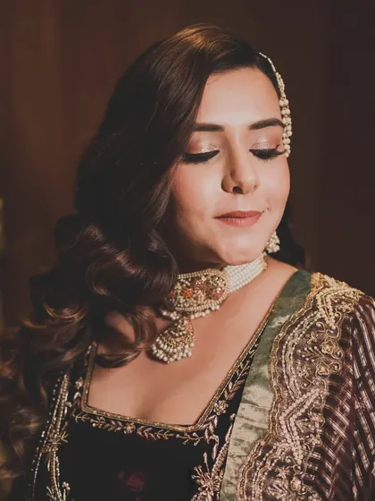A close-up of the bride's flawless makeup and elegant hairstyle, which perfectly completed her glamorous reception look.