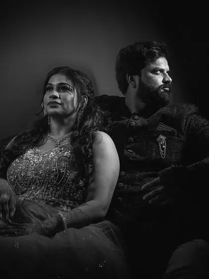 A dramatic black and white portrait of the engaged couple, using shadows to create a moody and intense look.