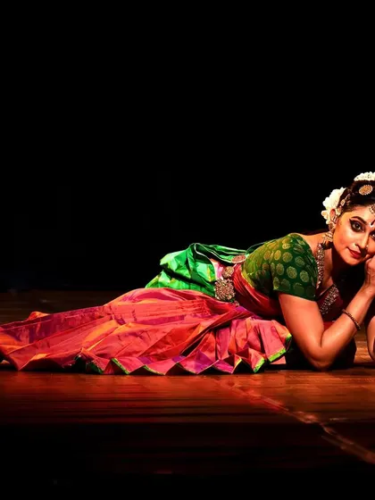 A restful, elegant pose on the stage floor at Narada Gana Sabha.