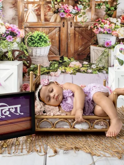 A beautiful, dreamy portrait of six month old Adira sleeping on a miniature bed surrounded by flowers. Milestone sessions can include both awake and sleepy shots.