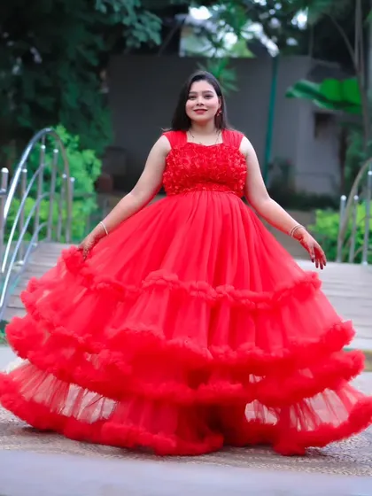 A full-length shot of a vibrant red ruffled maternity gown, perfect for making a bold statement in your photoshoot.