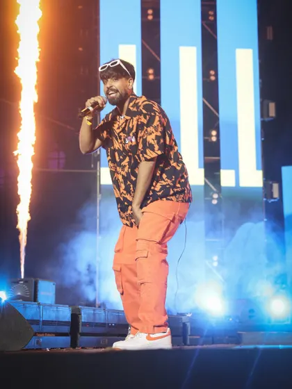 A shot of KhullarG next to a pillar of fire, capturing the peak excitement of the show. I am experienced in safely capturing pyrotechnics and other special effects.