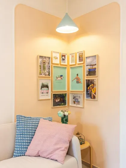 Our favorite part of designing is creating cozy corners. This accent frame wall adds a personal touch and a splash of color to the living room.