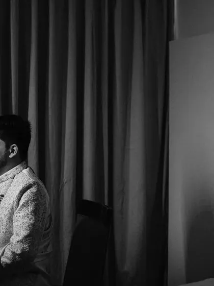 A quiet, contemplative portrait of the groom in black and white. The simple composition and the use of shadow give this image a timeless, cinematic quality. Same as 47.