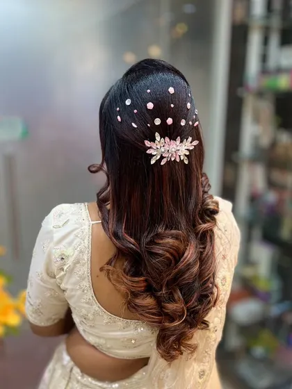 This hairstyle features a cascade of sparkling crystals over a voluminous half-updo. It’s a glamorous look perfect for a cocktail party, and students learn the technique for placing individual gems securely.