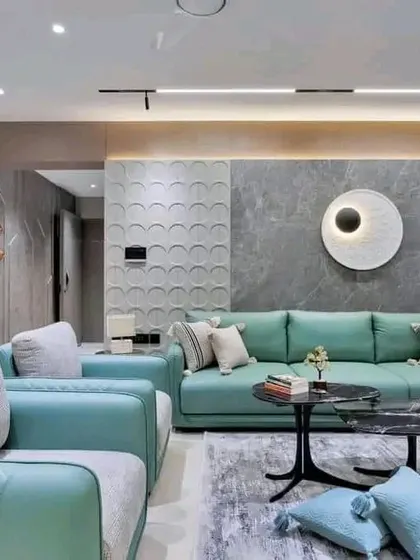 The main seating area with a comfortable mint-green sofa, textured wall panels, and modern art, creating a sophisticated and contemporary living space.