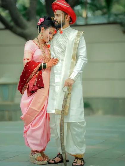 A tender and protective embrace. This portrait captures the groom's pride and the bride's serene happiness.