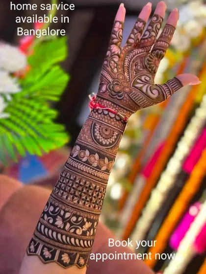 This design features intricate bands of patterns wrapping around the arm, creating a beautiful cuff effect. Home service is available in and around Bangalore.