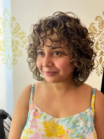 The highlights add dimension to the curly bob.