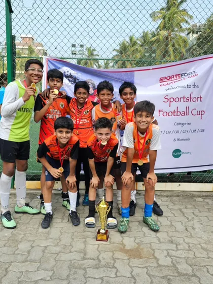 The U13 team posing with their trophy after winning the Sportfort Football Cup.